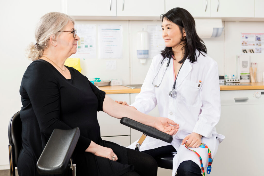 Phlebotomist carrying out blood test appointment booked through phlebotomy booking system